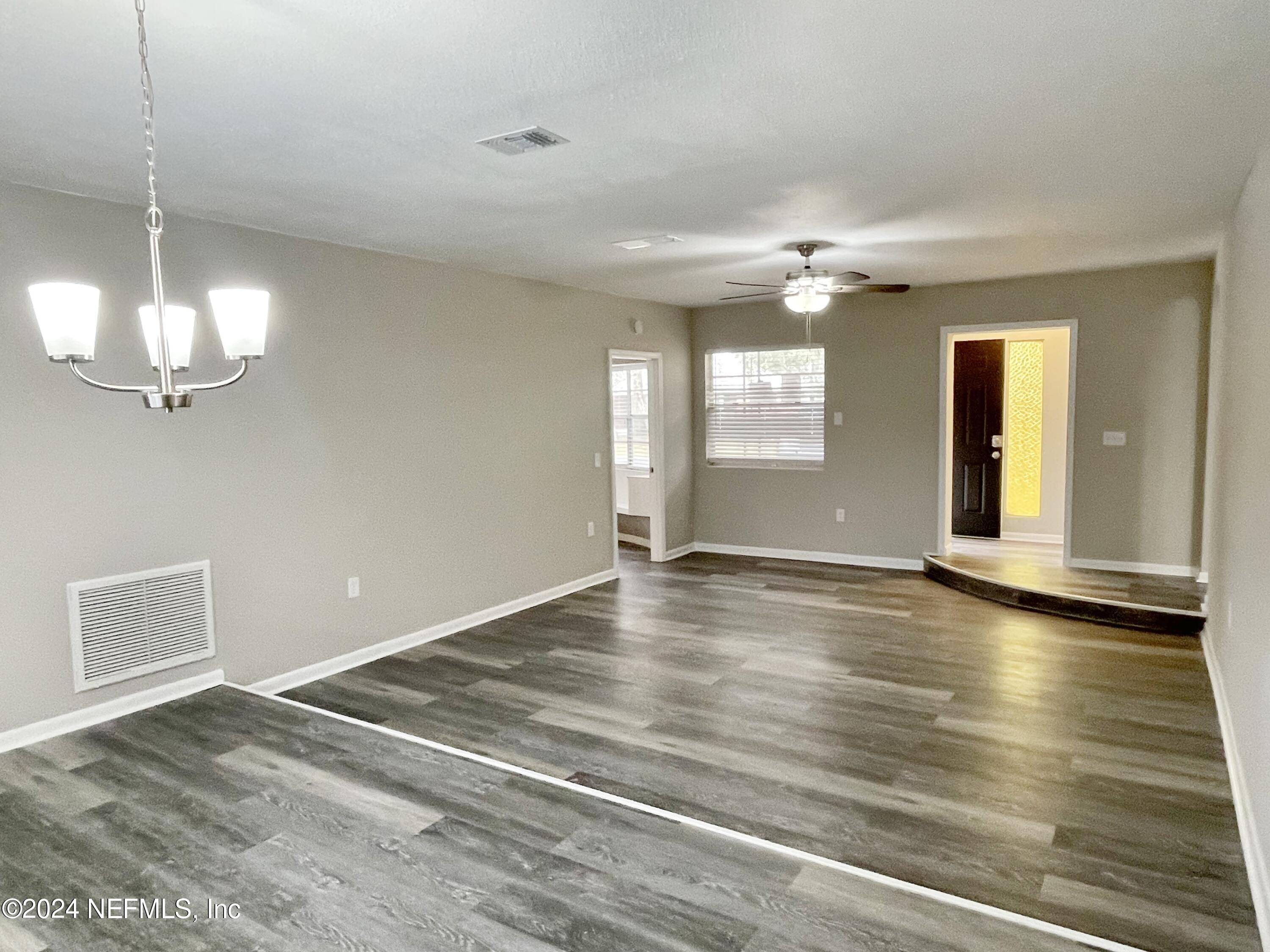 830 Gerona Road St. Augustine, FL 32086 - Photo 14 of 27 a view of an empty room with window and wooden floor