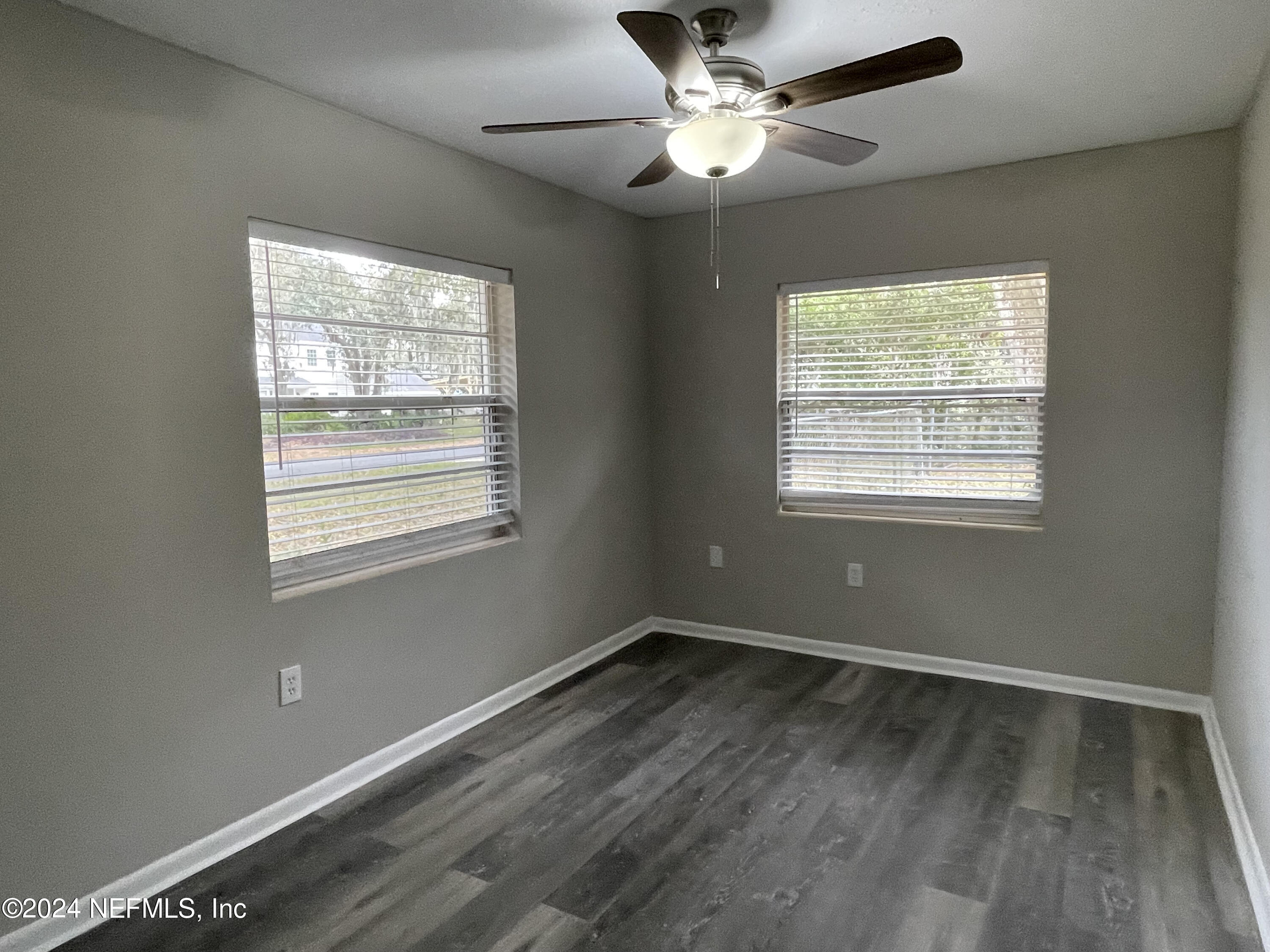 830 Gerona Road St. Augustine, FL 32086 - Photo 15 of 27 a view of an empty room with wooden floor and a window