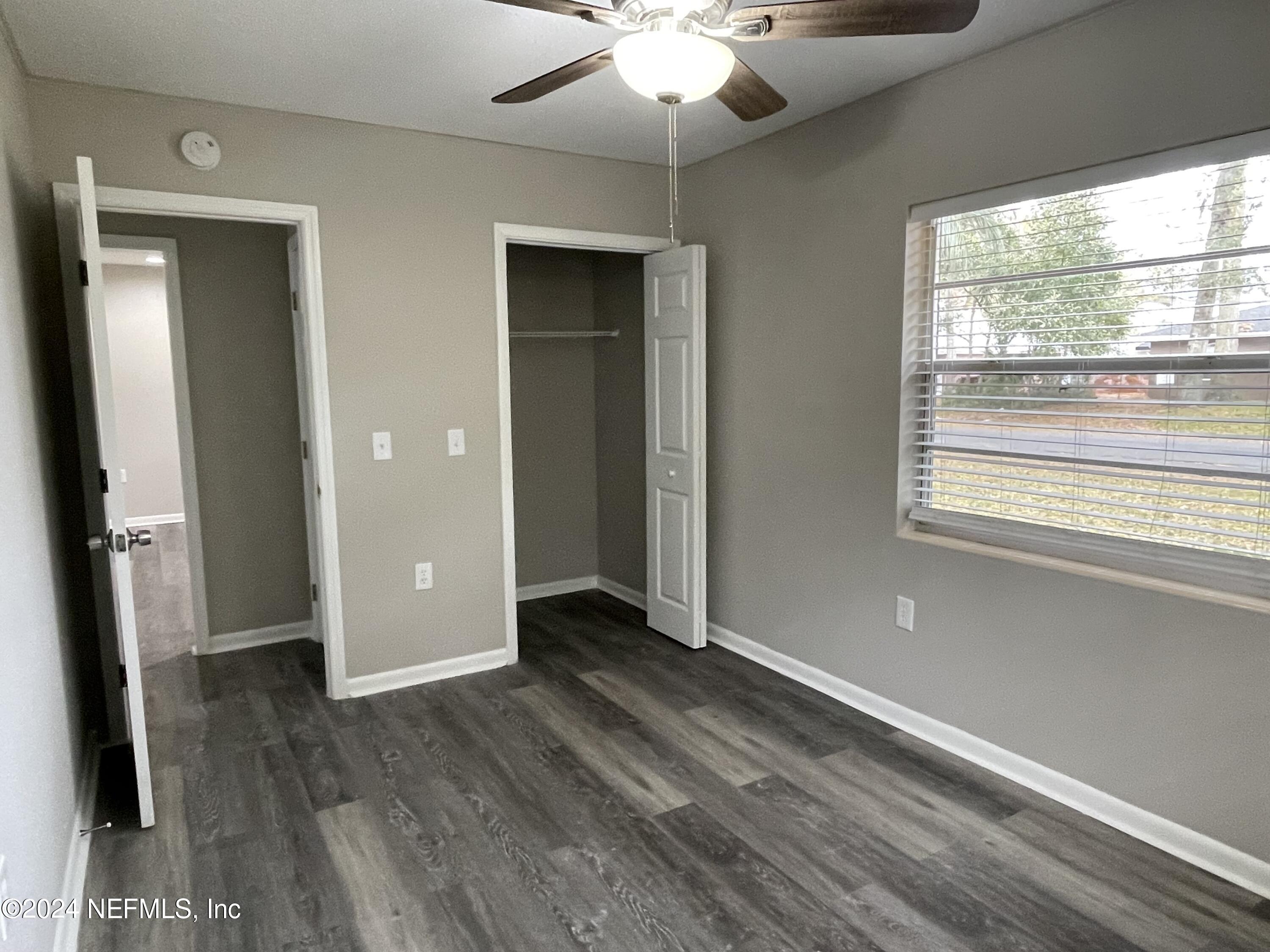 830 Gerona Road St. Augustine, FL 32086 - Photo 16 of 27 a view of an empty room with wooden floor and a window