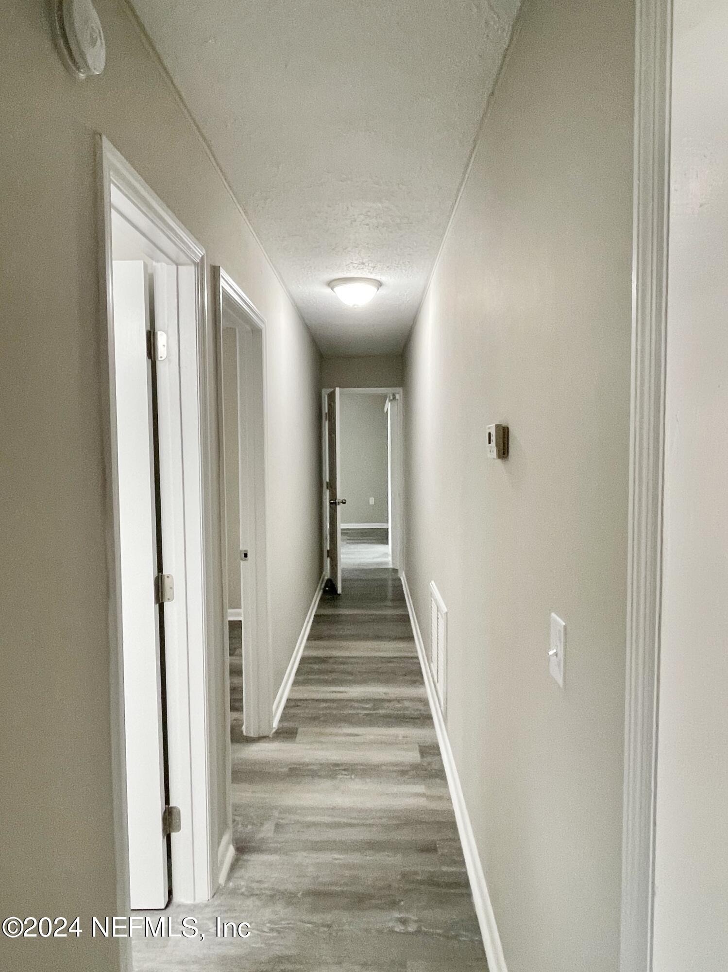 830 Gerona Road St. Augustine, FL 32086 - Photo 19 of 27 a view of a hallway with wooden floor and closet