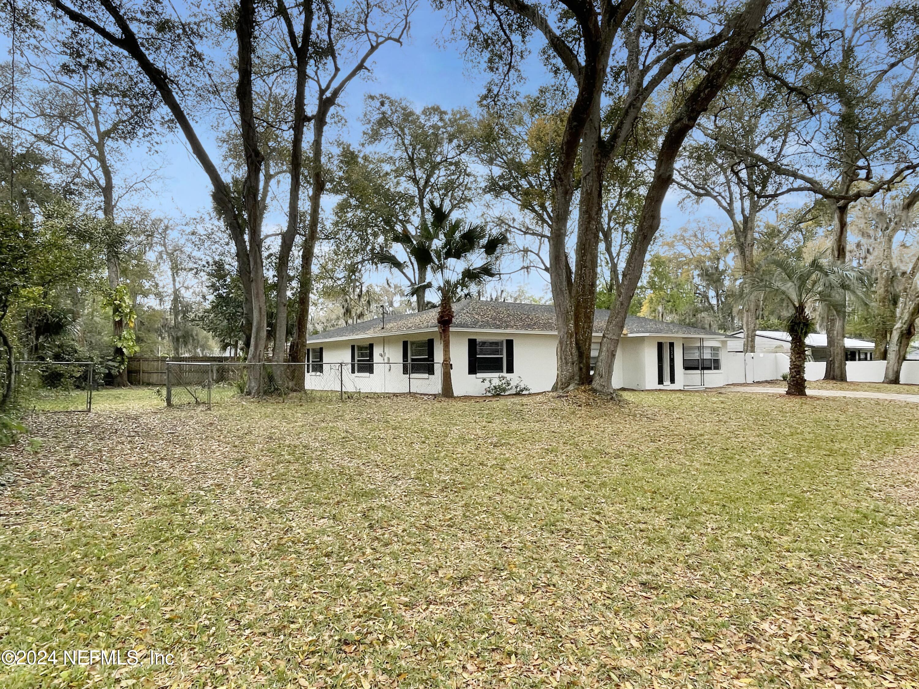 830 Gerona Road St. Augustine, FL 32086 - Photo 2 of 27 a front view of a house with a garden