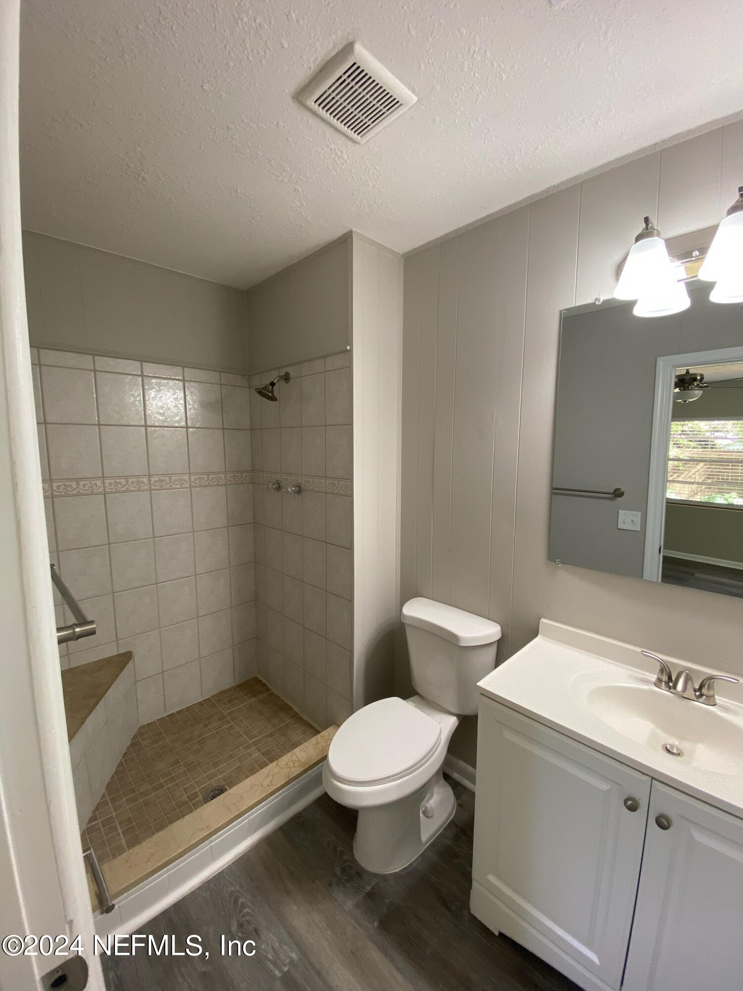 830 Gerona Road St. Augustine, FL 32086 - Photo 21 of 27 a bathroom with a granite countertop sink a toilet a mirror and shower