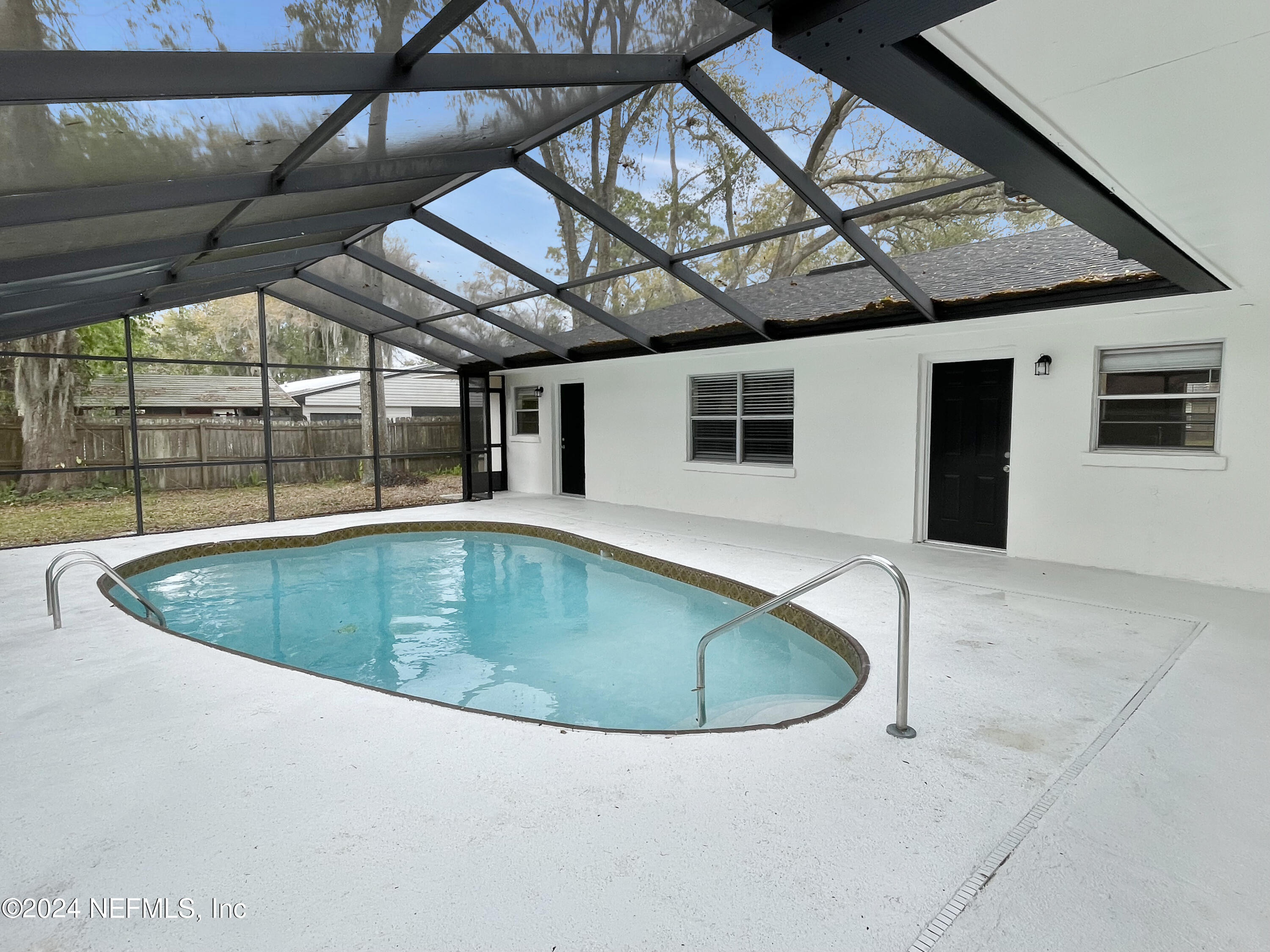 830 Gerona Road St. Augustine, FL 32086 - Photo 23 of 27 a view of a swimming pool with a yard