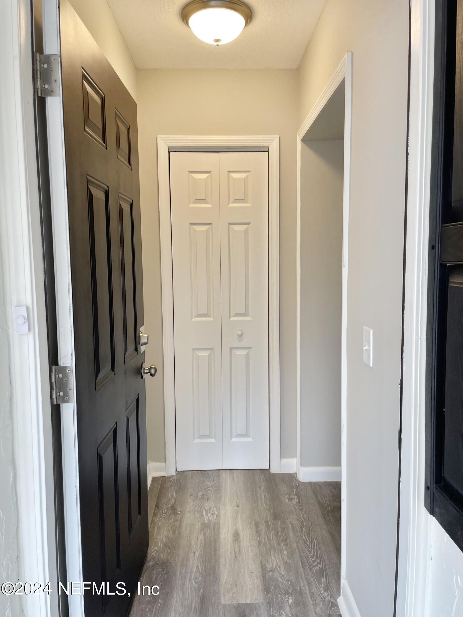 830 Gerona Road St. Augustine, FL 32086 - Photo 3 of 27 a view of a hallway with wooden floor and staircase