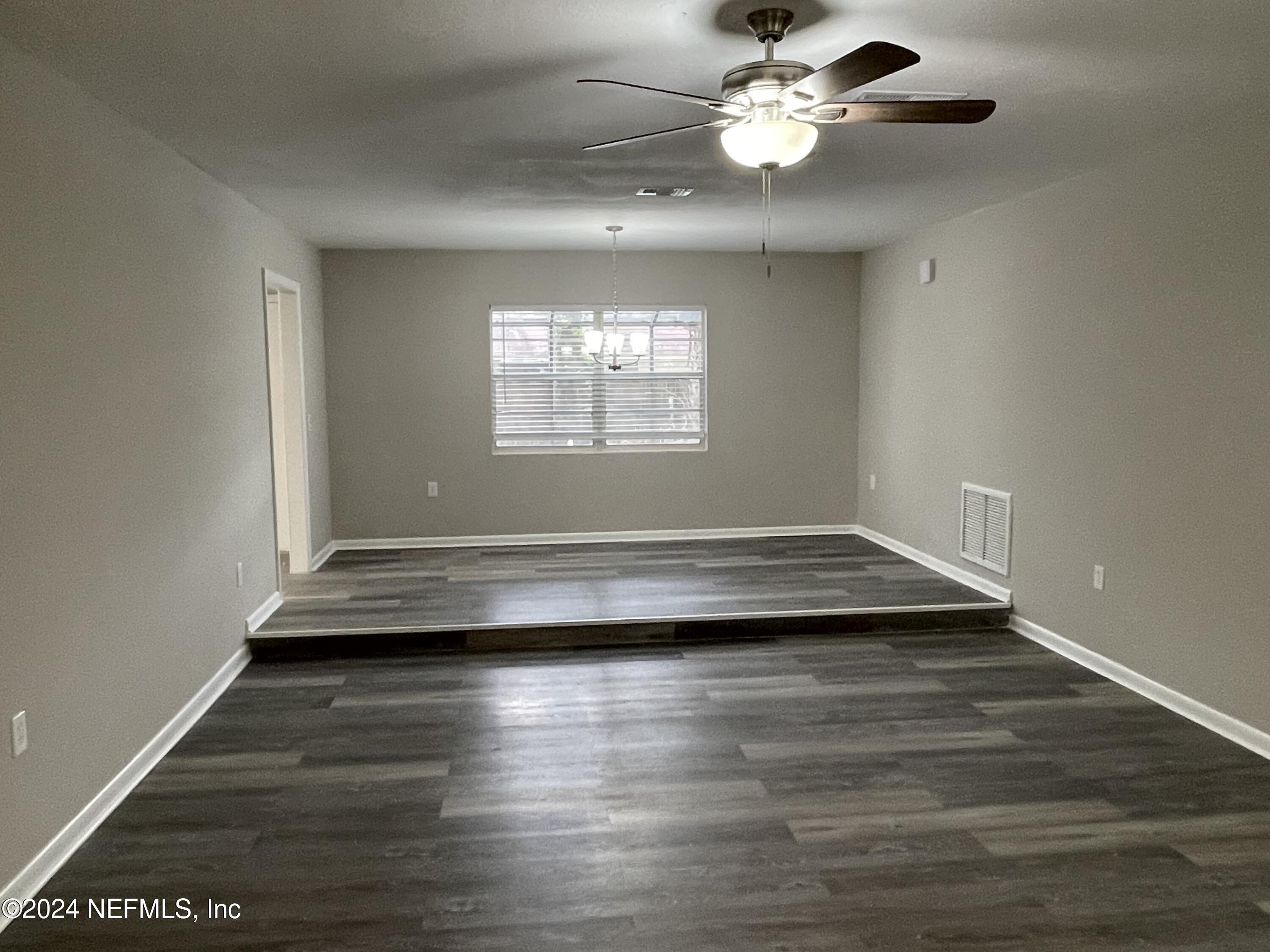830 Gerona Road St. Augustine, FL 32086 - Photo 4 of 27 a view of empty room with wooden floor and fan