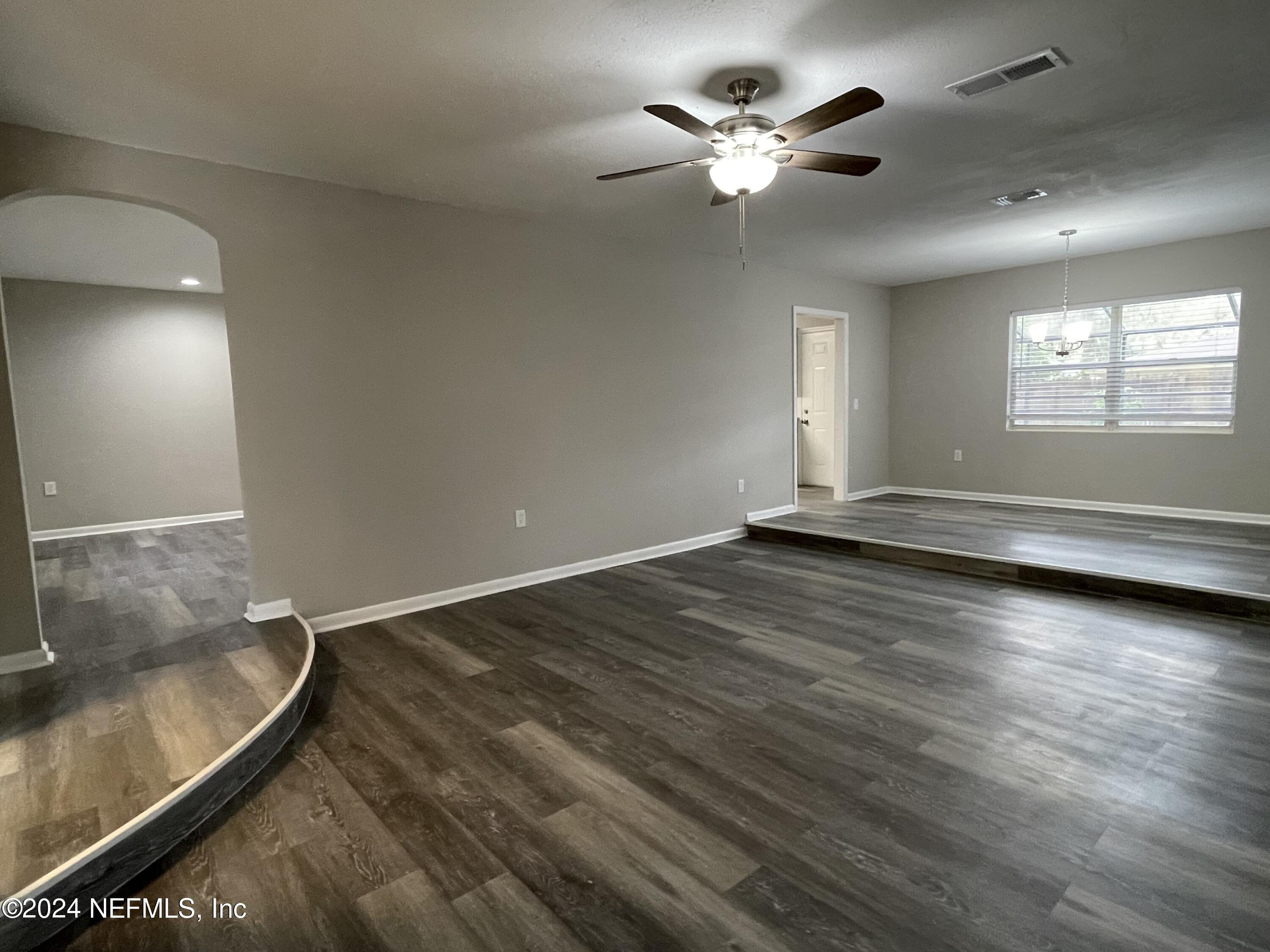 830 Gerona Road St. Augustine, FL 32086 - Photo 5 of 27 wooden floor in an empty room with a window