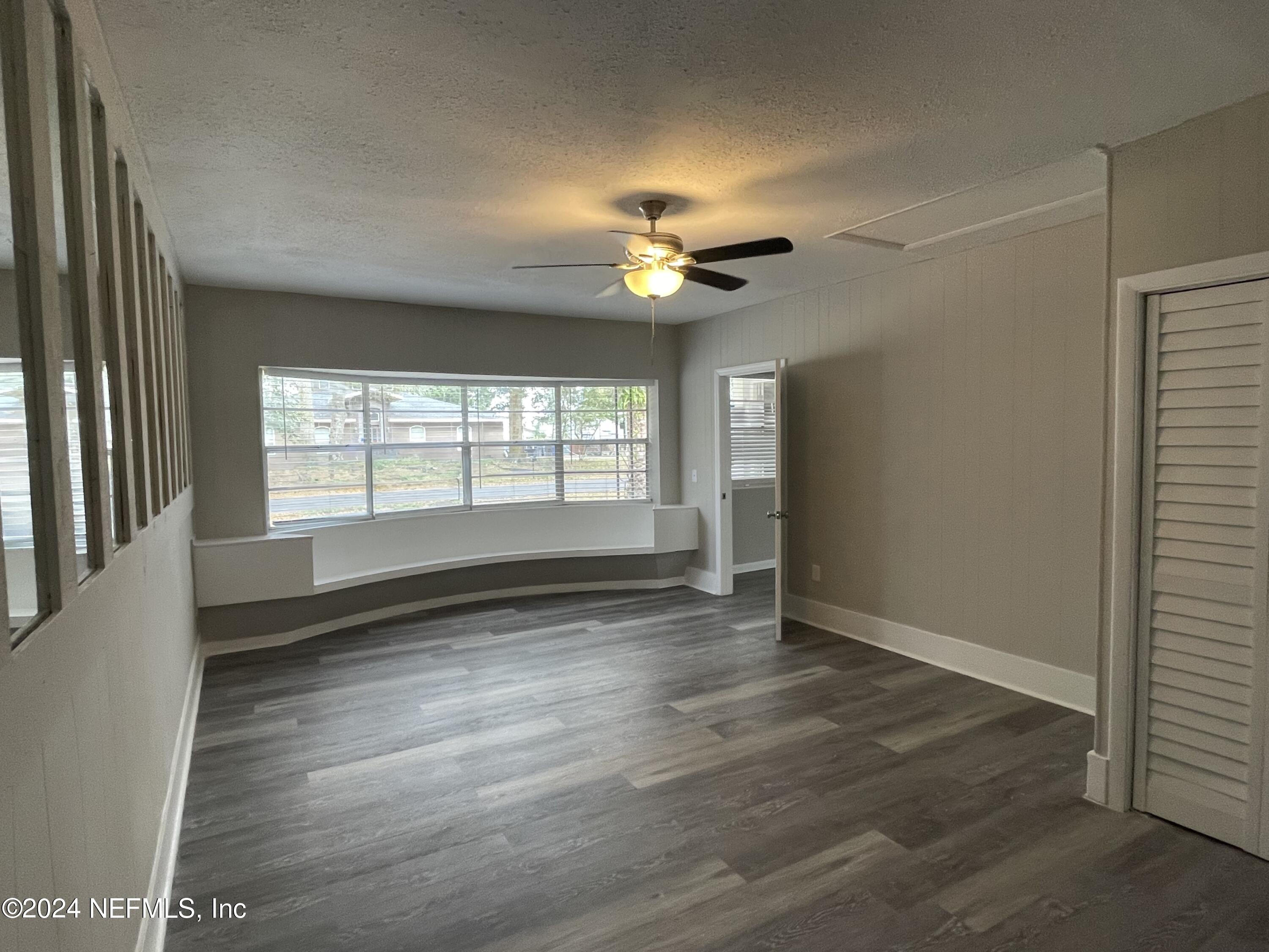 830 Gerona Road St. Augustine, FL 32086 - Photo 7 of 27 an empty room with wooden floor and windows
