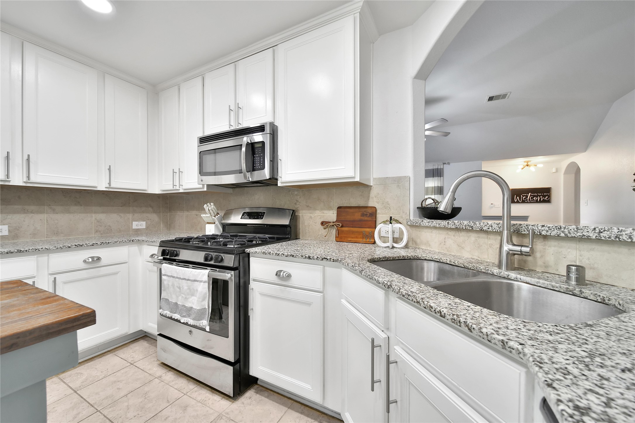 1279 Pinto Pass Alvin, TX 77511 - Photo 9 of 31 a kitchen with granite countertop white cabinets sink and stainless steel appliances