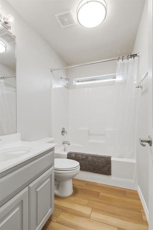 817 Huebner Way Burleson, TX 76028 - Photo 24 of 35 Guest bath has been updated with painted cabinets, wood look porcelain tile flooring and fresh paint.