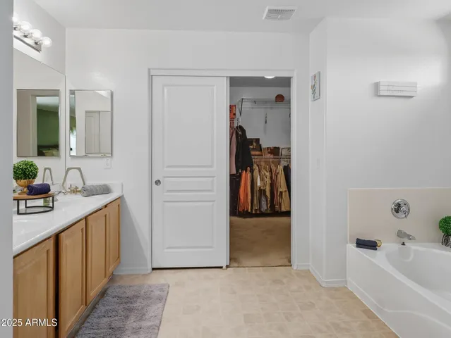 a hallway with a sink and a refrigerator
