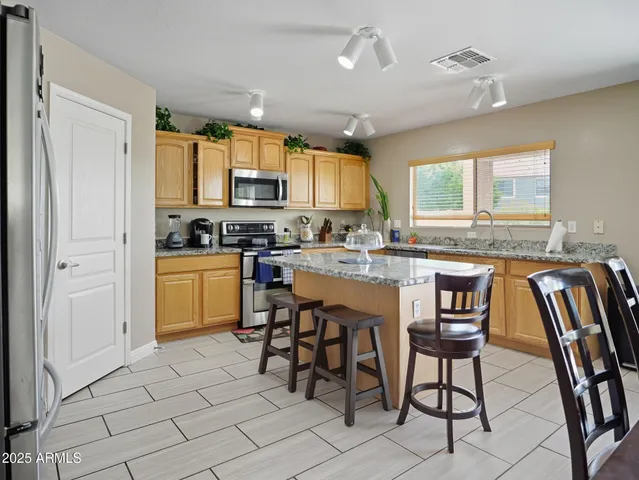 a kitchen with a sink cabinets and window
