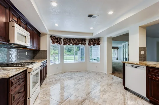 a kitchen with stainless steel appliances granite countertop a stove and a sink