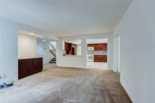 a view of a big room with wooden cabinet and windows