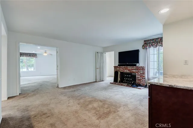 a view of a workspace with furniture and a flat screen tv