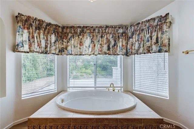a bathroom with a bathtub and window