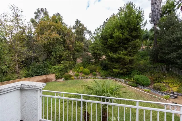 a view of a balcony with yard