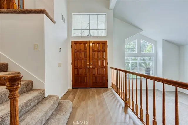 a view of a hallway with windows and stairs