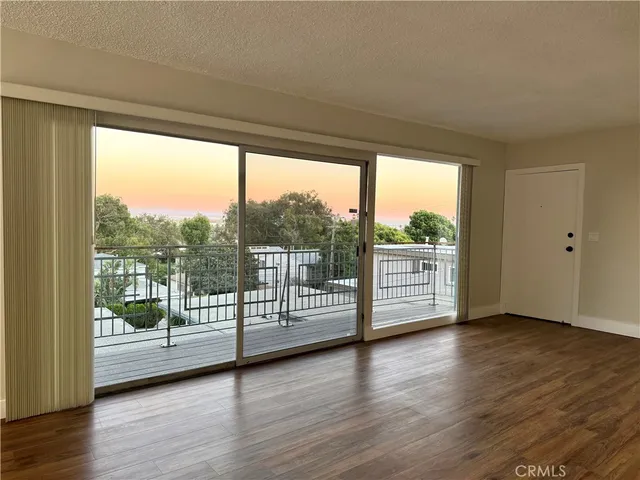 a view of wooden floor and windows in an empty room