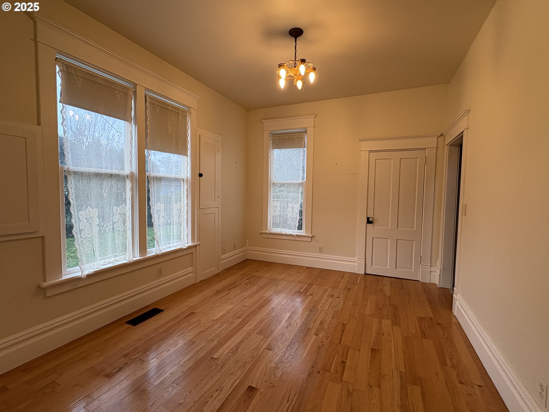 430 West Water Street Stayton, OR 97383 - Photo 12 of 42 a view of an empty room with a window and wooden floor