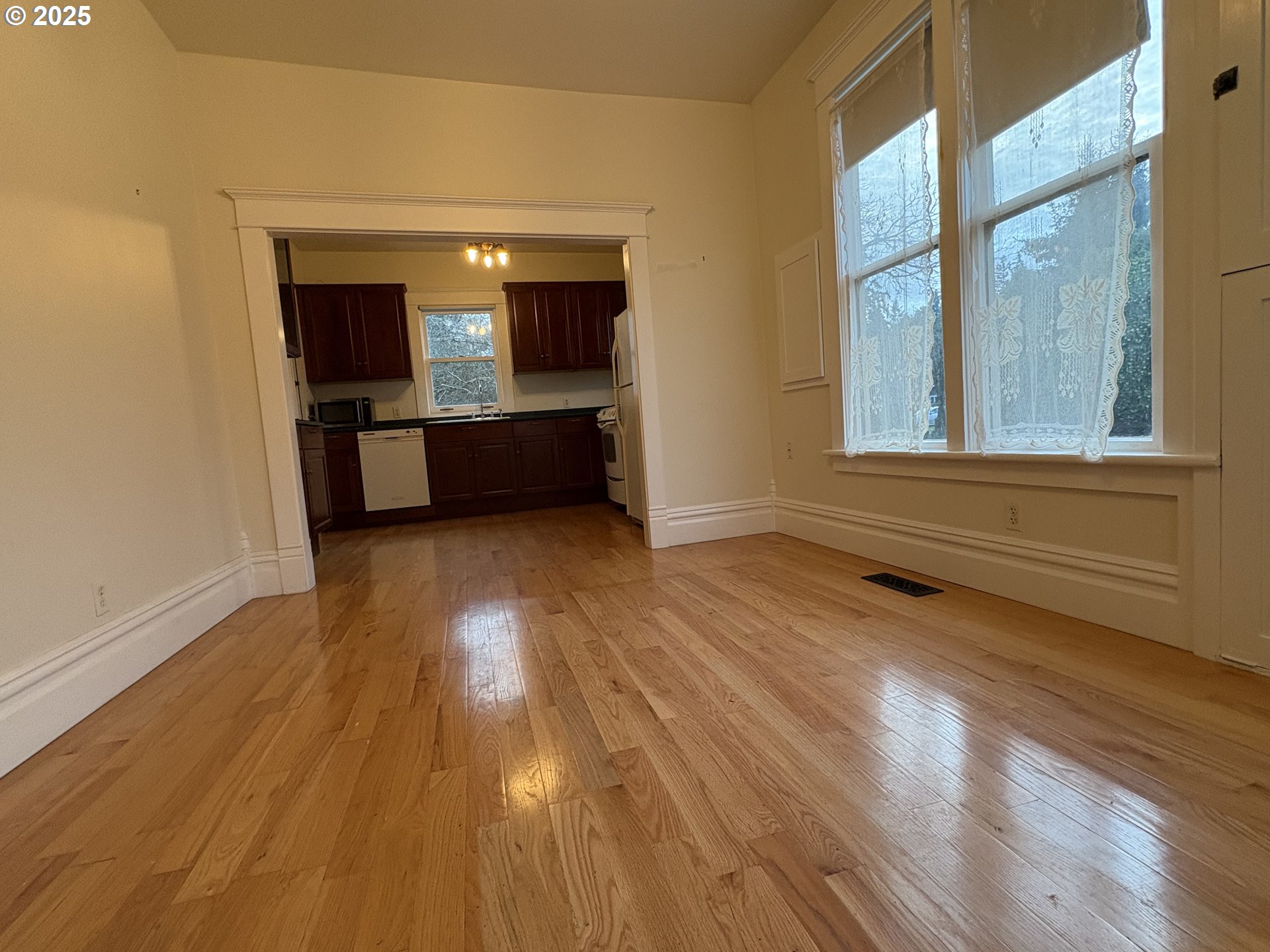 430 West Water Street Stayton, OR 97383 - Photo 13 of 42 a view of a hallway with wooden floor and a kitchen