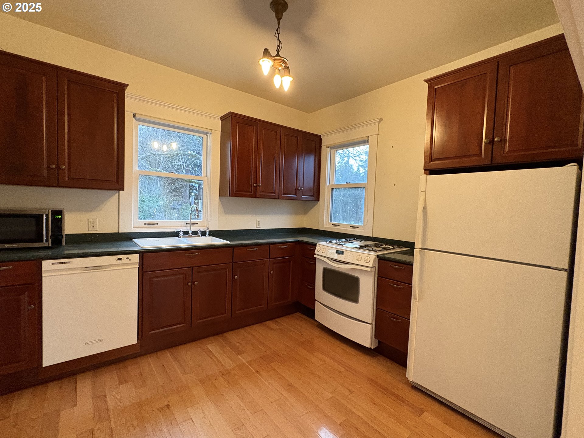 430 West Water Street Stayton, OR 97383 - Photo 14 of 42 a kitchen with stainless steel appliances granite countertop a refrigerator a sink dishwasher a stove top oven a refrigerator and cabinets with wooden floor
