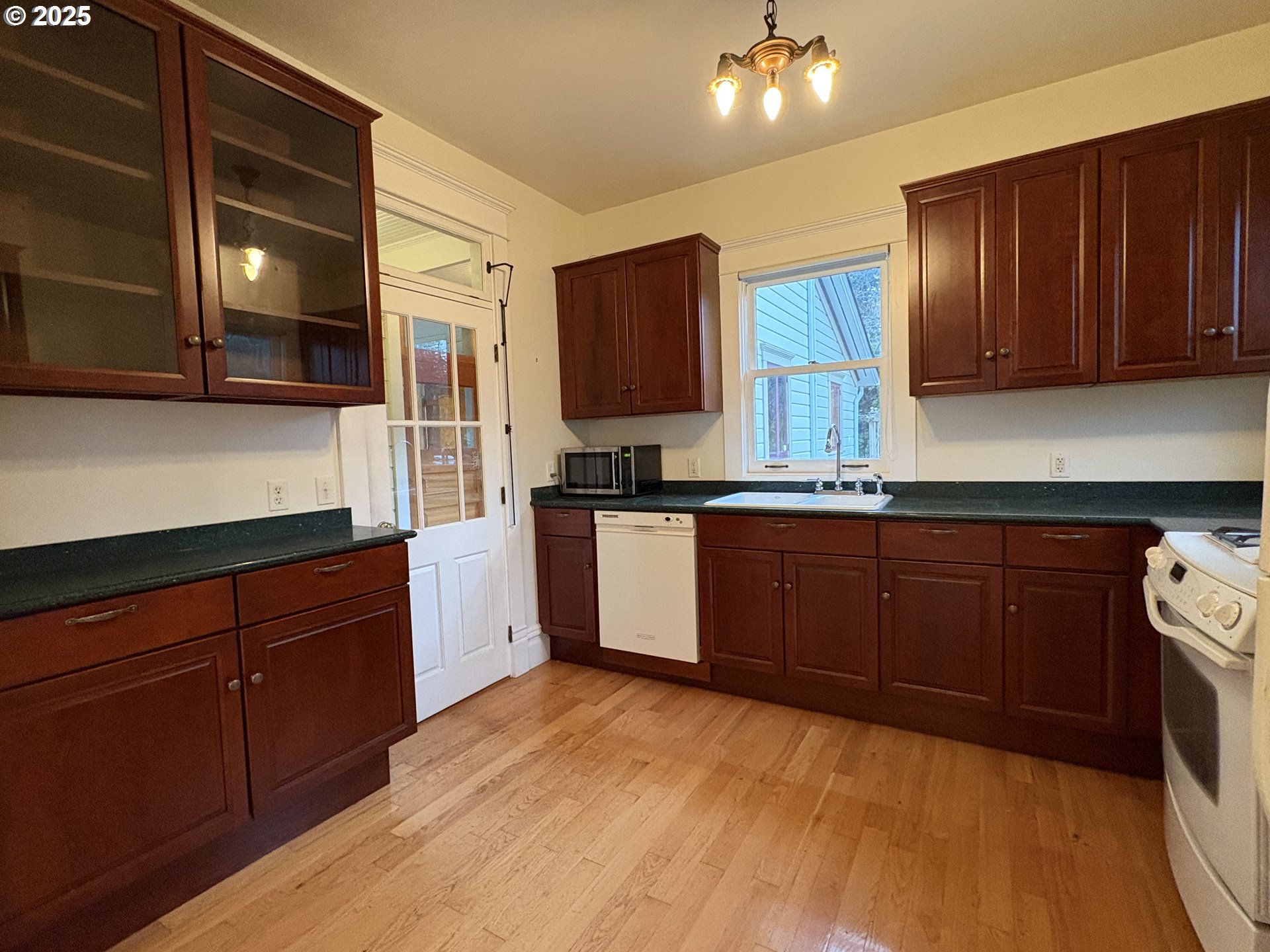 430 West Water Street Stayton, OR 97383 - Photo 15 of 42 a kitchen with stainless steel appliances granite countertop wooden cabinets a stove top oven a sink and dishwasher