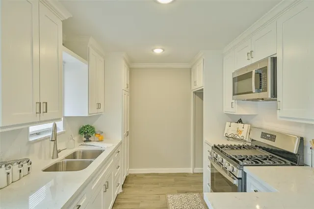 a kitchen that has a sink and a stove