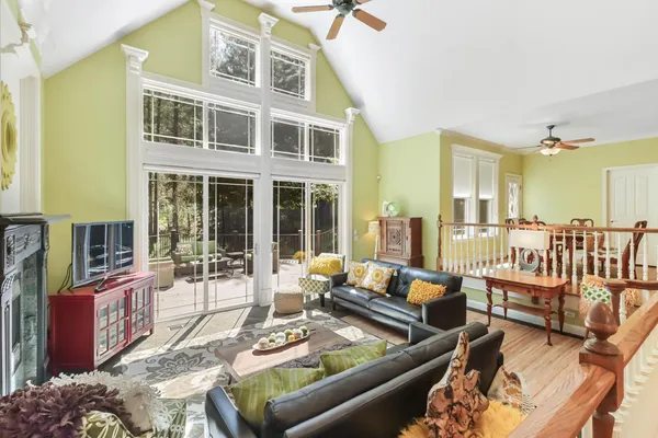 a kitchen with kitchen island stainless steel appliances a stove a refrigerator a sink dishwasher with a dining table and chairs