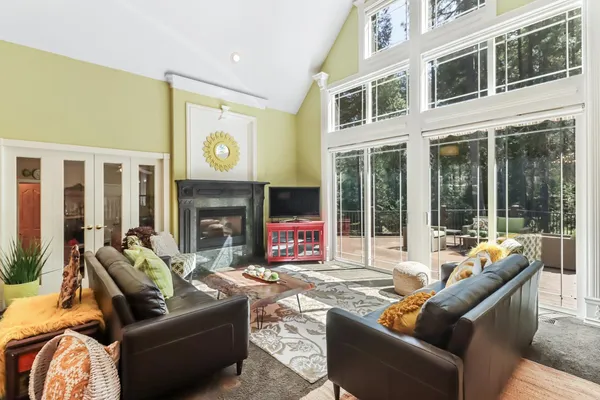 a kitchen with stainless steel appliances granite countertop a sink a counter space and a view of living room