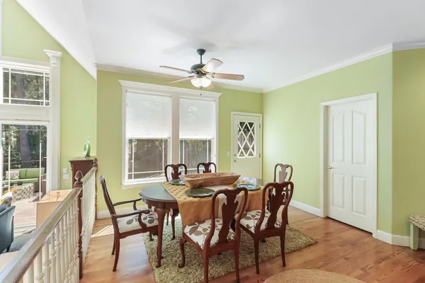 a spacious bathroom with a double vanity sink a large mirror a bathtub and next to a window