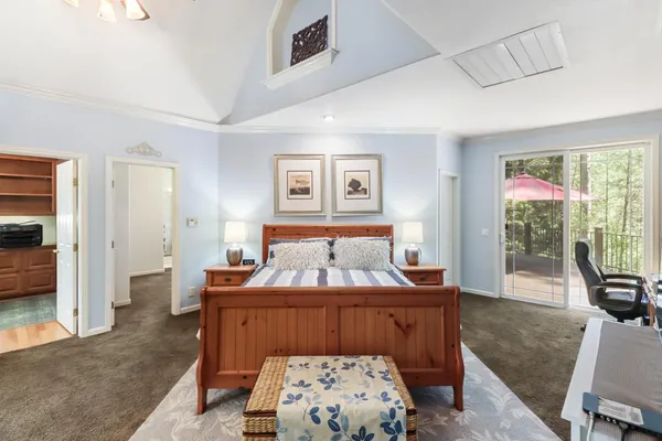 a view of empty room with wooden floor and ceiling fan