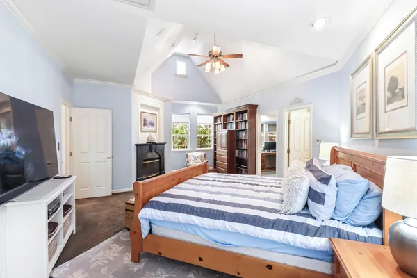 an empty room with wooden floor and ceiling fan