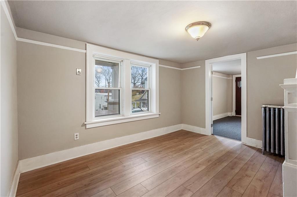 528 3rd Street Charleroi, PA 15022 - Photo 8 of 50 a view of an empty room with wooden floor and a window
