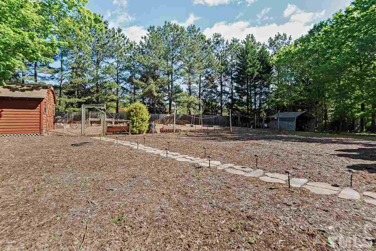 3005 Daventry Lane Raleigh, NC 27613 - Photo 30 of 30 Used the shed as a workshop or for all your gardening tools. Raised beds already to go for your veggie garden. Deer fencing already place!