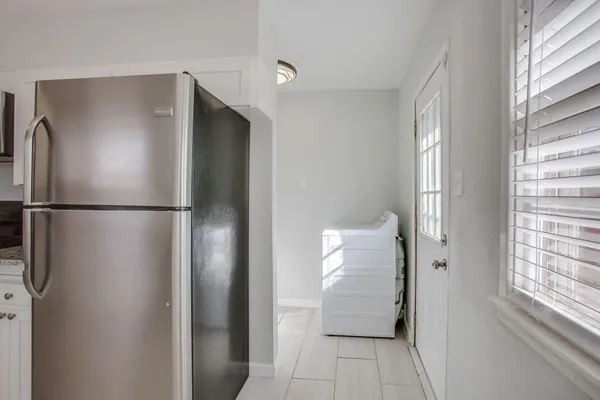 a view of a walk in closet and wooden floor
