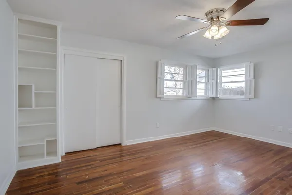 a view of a room with a window and wooden floor