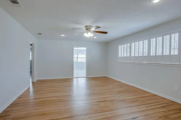 wooden floor in an empty room with a window