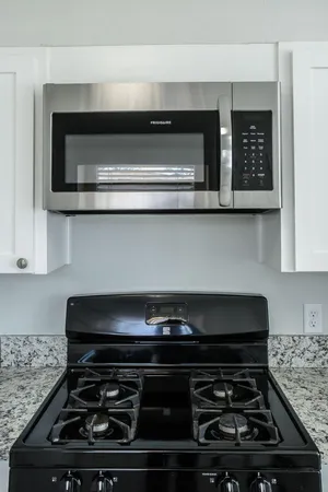 a stove top oven sitting inside of a kitchen