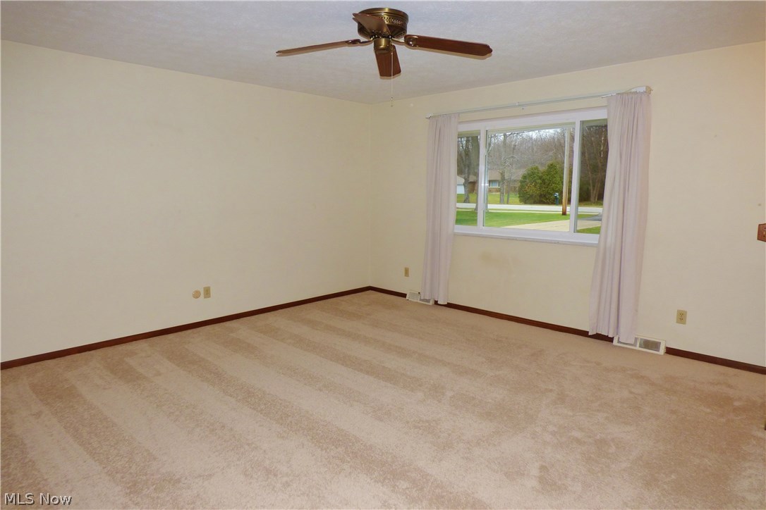 31280 Miles Road Solon, OH 44139 - Photo 6 of 29 The large Living Room with new carpet, newer replacement windows and ceiling fan. This room is open to the Dining Room as well.
