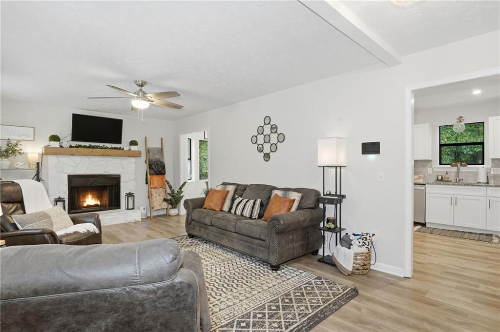 404 Brooks Street Dallas, GA 30157 - Photo 2 of 38 a living room with furniture a fireplace and a flat screen tv