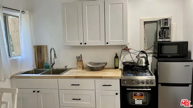 a kitchen with a stove and a refrigerator