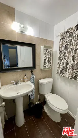 a bathroom with a toilet sink and mirror
