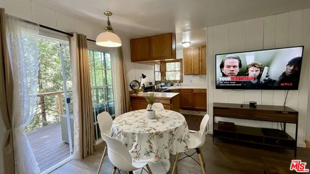 a view of a dining room with furniture a chandelier and wooden floor