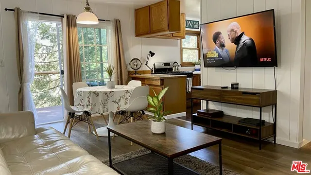 a dining room with furniture and wooden floor