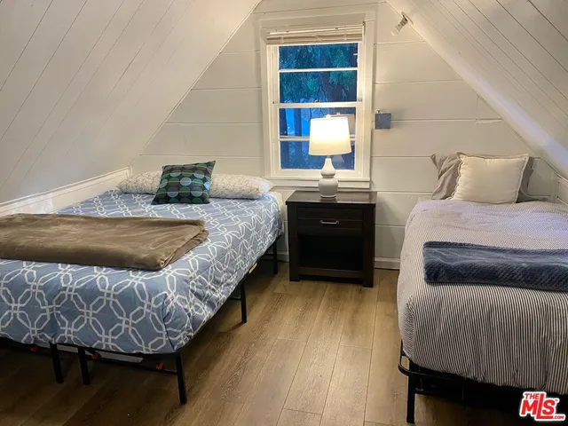 a bedroom with bed and dresser