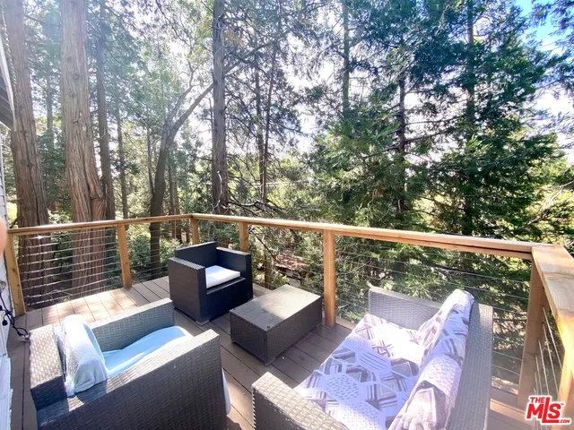 a view of a balcony with couches and wooden floor