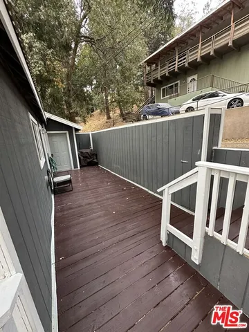 a view of deck with wooden floor and fence