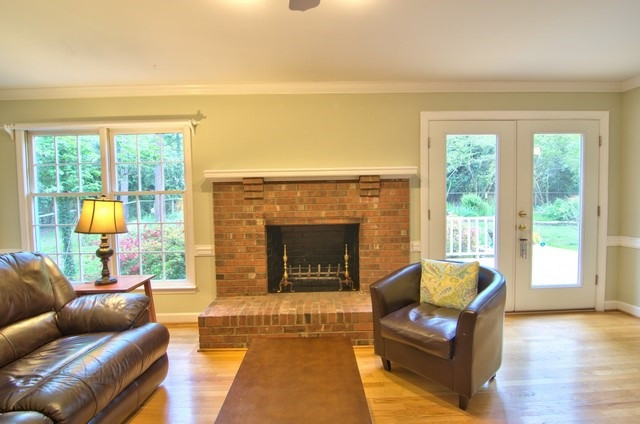 5811 Woodberry Road Durham, NC 27707 - Photo 12 of 25 The masonry fireplace is flanked by floor to ceiling windows and French door to deck. Family Room