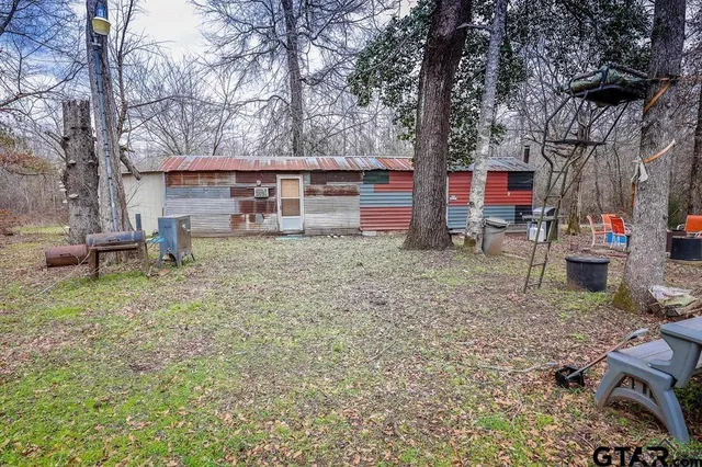a view of a house with a yard and sitting area