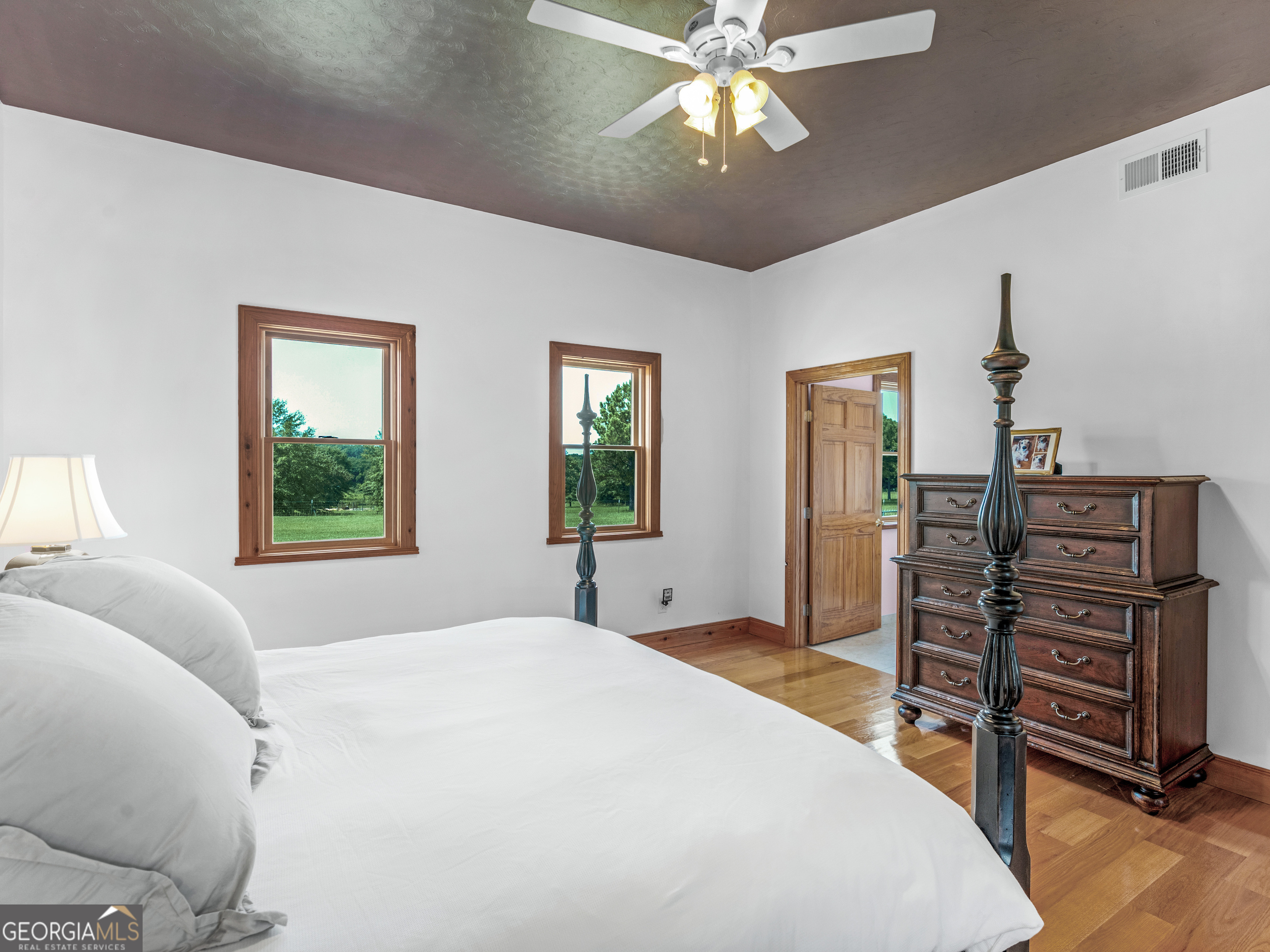 2051 Gough Road Louisville, GA 30434 - Photo 13 of 95 a bedroom with a bed and a chandelier